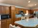 Bright kitchen featuring tiled countertops, oak cabinetry, and stainless steel appliances at 20971 Negril Ct, Lutz, FL 33558