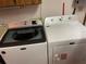 Updated laundry area features modern Maytag washer and dryer sets for efficient home convenience at 20971 Negril Ct, Lutz, FL 33558