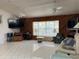 Spacious living room featuring a window seat, wood paneling, and tile floors at 20971 Negril Ct, Lutz, FL 33558