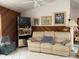 Comfortable living room featuring a sofa, accent chair, and display cabinet with shelving at 20971 Negril Ct, Lutz, FL 33558