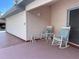 Cozy porch with two rocking chairs and a small table with tasteful decorations at 20971 Negril Ct, Lutz, FL 33558