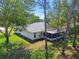 Home exterior view featuring a screened patio and lawn at 2183 Westchester Blvd, Spring Hill, FL 34606