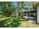 This backyard features a screened in patio area and green space at 2183 Westchester Blvd, Spring Hill, FL 34606