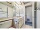 The full bathroom features a single sink vanity and decorative wallpaper at 2183 Westchester Blvd, Spring Hill, FL 34606