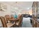 Formal dining area with a classic chandelier, seamlessly flows into the spacious living room at 2183 Westchester Blvd, Spring Hill, FL 34606