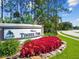 Timber Pines welcome sign surrounded by colorful plants and lush landscaping at 2183 Westchester Blvd, Spring Hill, FL 34606