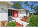 Inviting front porch with seating area, enhanced by lovely landscaping and pathway lighting at 2183 Westchester Blvd, Spring Hill, FL 34606