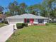 Charming one-story home with a well-manicured lawn and cozy front porch at 2183 Westchester Blvd, Spring Hill, FL 34606