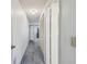Hallway view with blue carpet, closet with white doors and view of the room through the doorway at 2183 Westchester Blvd, Spring Hill, FL 34606