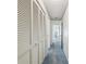 Hallway features blue carpeting, large closets, and access to bedrooms and bathrooms at 2183 Westchester Blvd, Spring Hill, FL 34606