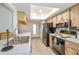 Well-lit kitchen featuring modern appliances, light wood cabinets, and plenty of storage space at 2183 Westchester Blvd, Spring Hill, FL 34606