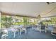 Enclosed lanai with tables and chairs overlooking the landscaped backyard at 2183 Westchester Blvd, Spring Hill, FL 34606
