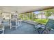Relaxing screened lanai with lounge chair and garden views, perfect for enjoying the outdoors at 2183 Westchester Blvd, Spring Hill, FL 34606
