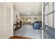 Open-concept living area with blue carpet, features a view of dining and sitting area at 2183 Westchester Blvd, Spring Hill, FL 34606