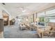 Bright living room with wicker furniture and many windows with natural light at 2183 Westchester Blvd, Spring Hill, FL 34606