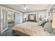 Comfortable main bedroom with large bed, dresser, soft lighting, and view of living area at 2183 Westchester Blvd, Spring Hill, FL 34606