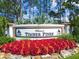 Welcome to Timber Pines sign with colorful landscaping and manicured hedges at 2183 Westchester Blvd, Spring Hill, FL 34606