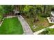 Aerial shot of the long private driveway, lush landscaping, and synthetic grass, with soccer goal at 2202 Amity Ct, New Port Richey, FL 34655