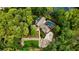 Beautiful birds eye view of home featuring a pool, mature trees, and a private lush backyard at 2202 Amity Ct, New Port Richey, FL 34655