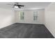 Spacious bedroom with new carpet, crown molding, a ceiling fan, and natural light from two windows at 2202 Amity Ct, New Port Richey, FL 34655