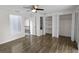 Bedroom featuring hardwood floors, a ceiling fan, and open closet spaces at 2202 Amity Ct, New Port Richey, FL 34655
