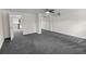 Large bedroom with neutral walls, new carpeting, a ceiling fan, and a mirrored closet at 2202 Amity Ct, New Port Richey, FL 34655