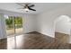 Bedroom with hardwood floors and sliding glass doors to a deck overlooking greenery at 2202 Amity Ct, New Port Richey, FL 34655