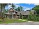 Charming two-story home featuring a welcoming front yard, upper deck, and lush landscaping at 2202 Amity Ct, New Port Richey, FL 34655