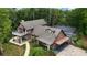 Exterior elevation view showcasing balcony, car port, and screened pool; surrounded by lush vegetation at 2202 Amity Ct, New Port Richey, FL 34655