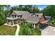 Aerial view of a two-story home with lush greenery, balcony, and an attached carport at 2202 Amity Ct, New Port Richey, FL 34655