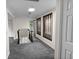 Bright hallway featuring gray carpet, skylight, and decorative wood accents at 2202 Amity Ct, New Port Richey, FL 34655