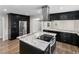 Modern kitchen with dark cabinets, stainless steel appliances and granite countertops on island at 2202 Amity Ct, New Port Richey, FL 34655