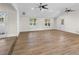 Open-concept living room featuring hardwood floors and French doors at 2202 Amity Ct, New Port Richey, FL 34655