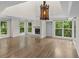 Bright and open living room featuring wood floors, a fireplace, and natural light from large windows at 2202 Amity Ct, New Port Richey, FL 34655