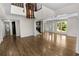 Open living space boasts wood floors, a decorative light fixture, and a view of the entry at 2202 Amity Ct, New Port Richey, FL 34655