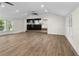 Bright, open living room with hardwood floors, ceiling fan, and large windows at 2202 Amity Ct, New Port Richey, FL 34655