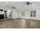 Spacious living room with hardwood floors, high ceilings, and French doors leading to outdoor area at 2202 Amity Ct, New Port Richey, FL 34655