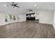 Spacious living room featuring vaulted ceiling, hardwood floors, and natural light from large windows at 2202 Amity Ct, New Port Richey, FL 34655