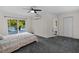 Primary bedroom with carpet floor, slider door access to deck and ensuite bathroom at 2202 Amity Ct, New Port Richey, FL 34655