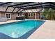 Covered pool area with pool and hot tub with a screened enclosure at 2202 Amity Ct, New Port Richey, FL 34655