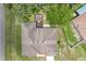 This aerial view showcases a cozy backyard fire pit and a charming single Gathering home at 2251 Evenglow Ave, Spring Hill, FL 34609