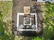 Aerial shot of the modern fire pit with cozy seating, providing a bird's-eye view of the outdoor entertainment space at 2251 Evenglow Ave, Spring Hill, FL 34609