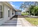 A cozy patio area featuring an outdoor rug and easy access to the home's backyard and the rest of the property at 2251 Evenglow Ave, Spring Hill, FL 34609