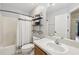 A bright bathroom featuring a shower and sink at 2251 Evenglow Ave, Spring Hill, FL 34609