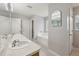 Neutral bathroom with double sink, large mirror, and soaking tub at 2251 Evenglow Ave, Spring Hill, FL 34609