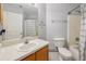 Cozy bathroom with tub, shower, vanity, commode, and handwritten note on the mirror at 2251 Evenglow Ave, Spring Hill, FL 34609