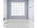 Bright bathroom with a window above the tub, offering natural light and privacy at 2251 Evenglow Ave, Spring Hill, FL 34609