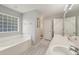 Spacious bathroom features a soaking tub, double sink vanity, and updated flooring at 2251 Evenglow Ave, Spring Hill, FL 34609