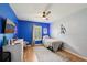 This bedroom features a ceiling fan and wood flooring at 2251 Evenglow Ave, Spring Hill, FL 34609