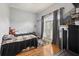 Bedroom features hardwood floors and a cozy aesthetic with large window at 2251 Evenglow Ave, Spring Hill, FL 34609